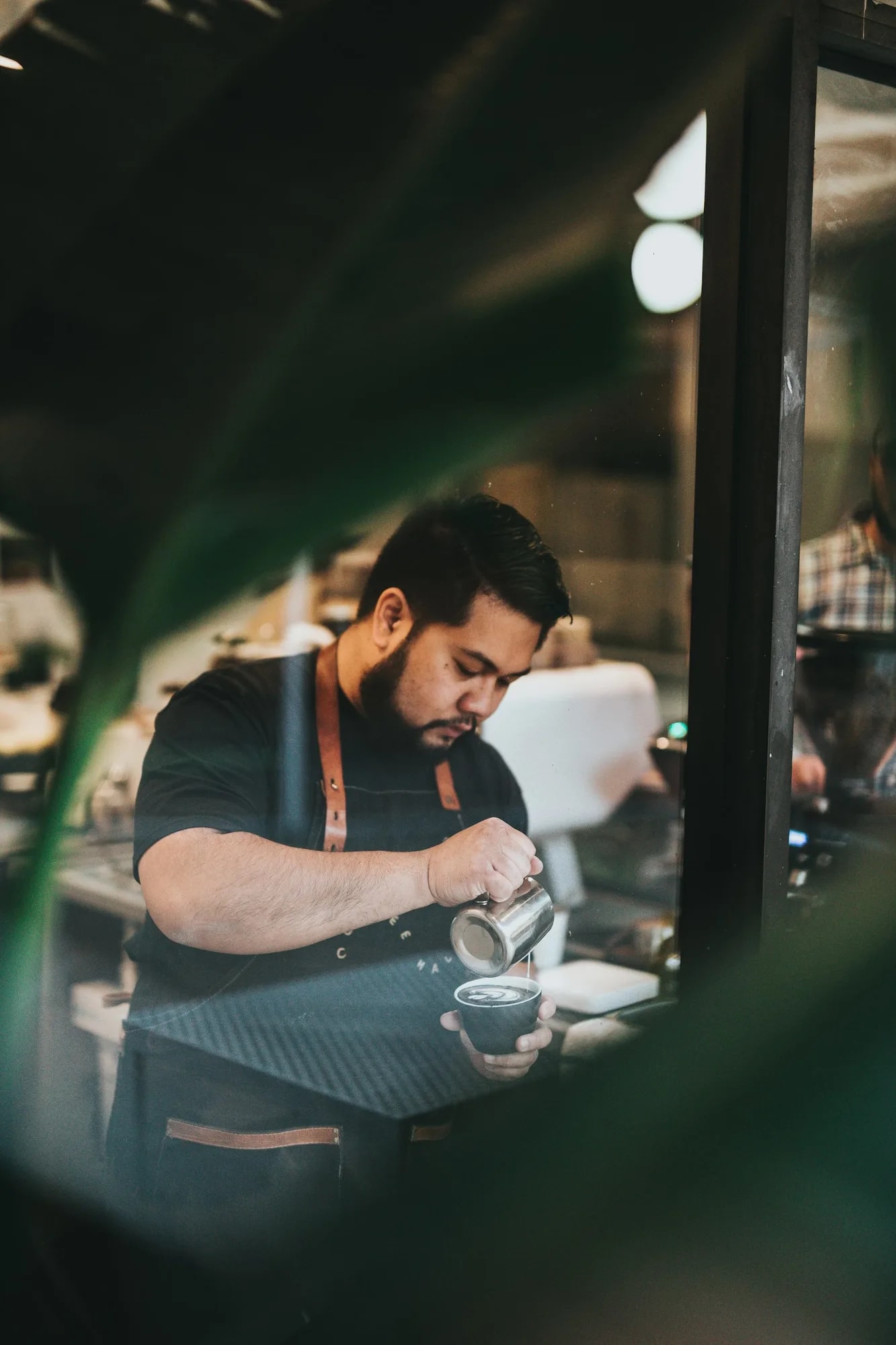 Hand pouring coffee into a cup during brewing